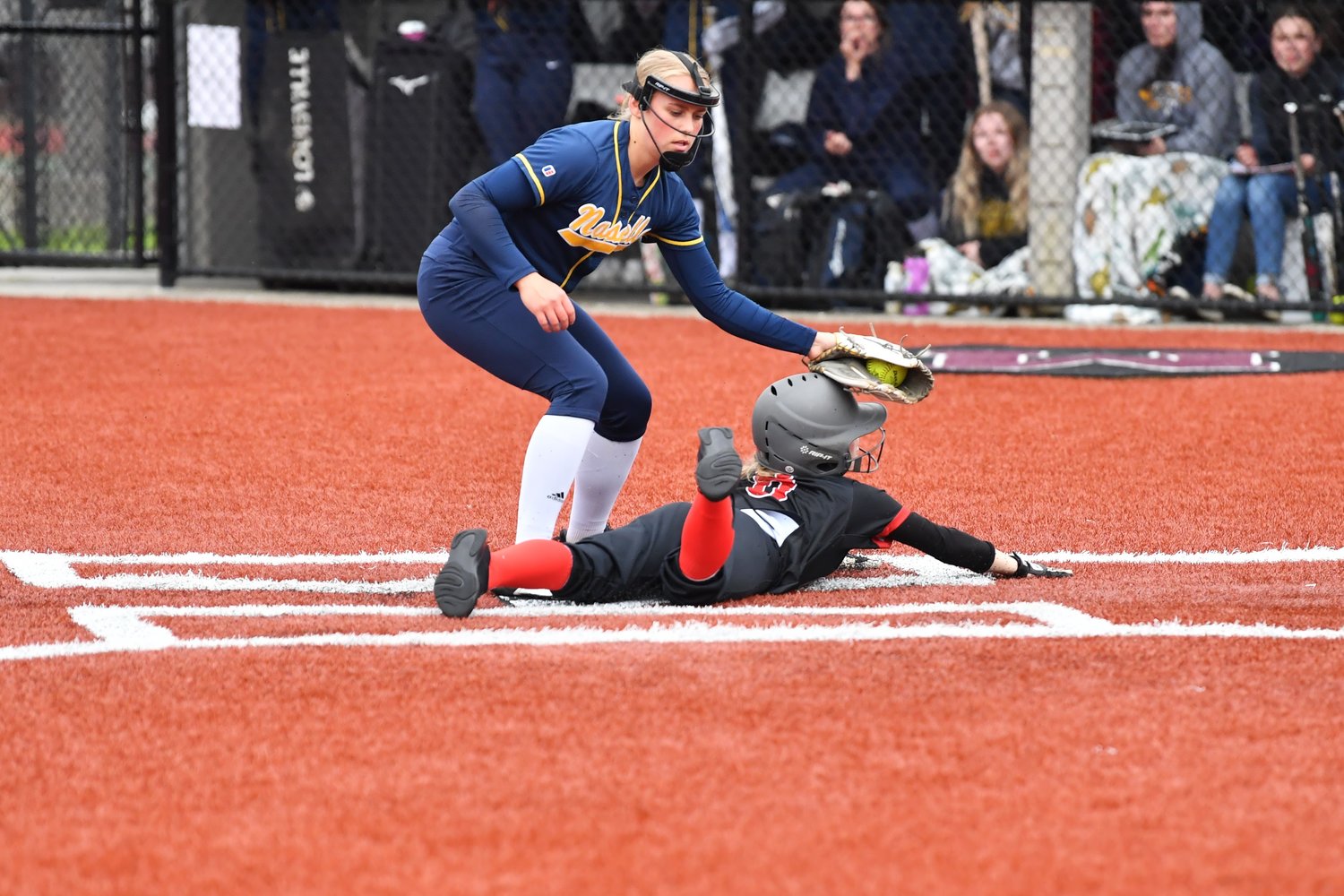 Addison Barrows slides in under the tag of Naselle pitcher Brynn Tarabochia on play at the plate after passed ball.